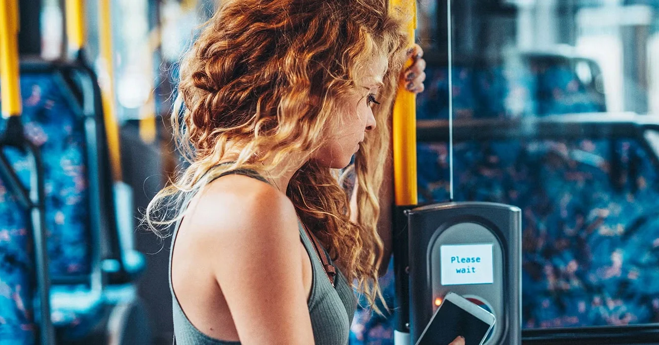 woman paying fare in transit pos system